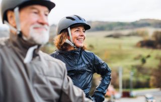 An active senior couple goes on a bike ride