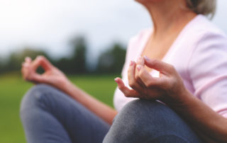 A senior woman meditating during yoga