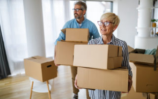 A happy senior couple with moving boxes