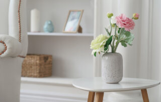 Fresh flowers in a vase sitting on a table in a modern, pretty apartment