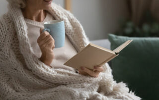 Woman drinking coffe in senior living community madison heights.