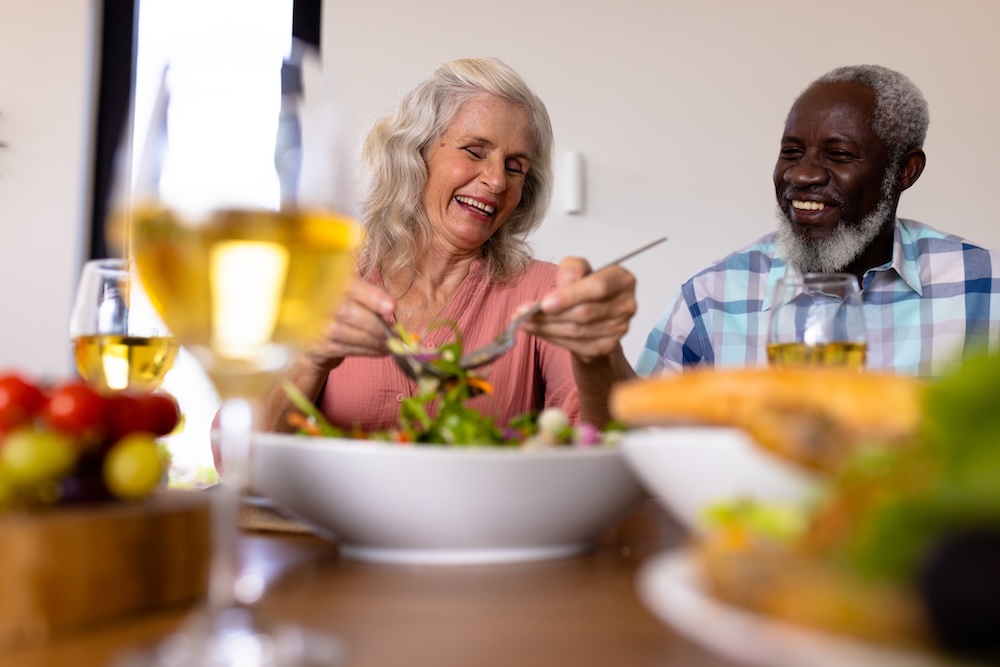 Senior couple enjoying a meal and talking about independent living options for seniors